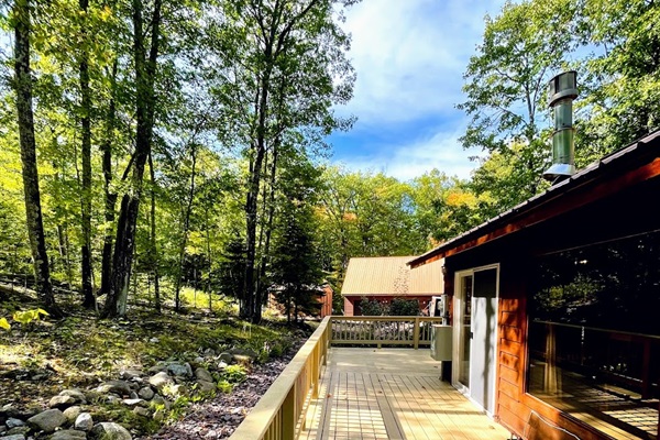side deck looking toward driveway and Rock Garden Cottage other cottage on property 100ft away see listing description for more information still very private 