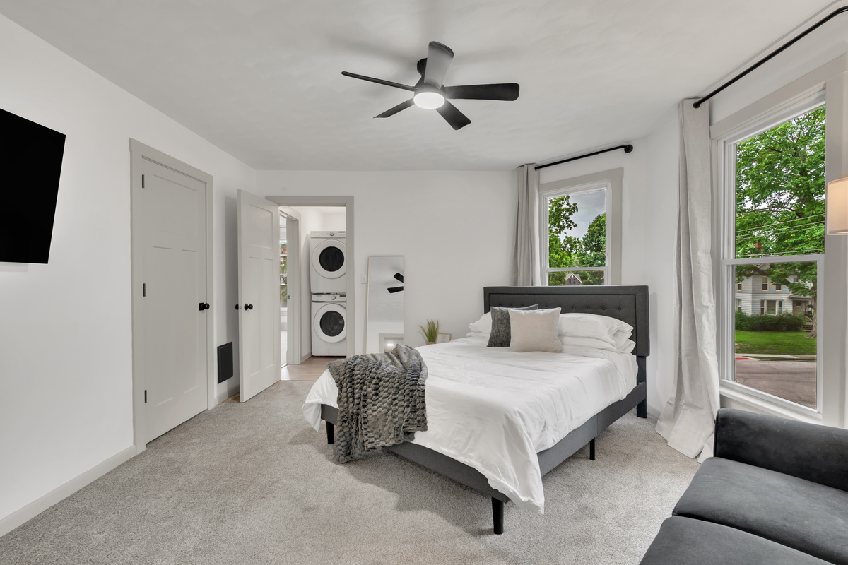 Queen bedroom with laundry access and locked door.