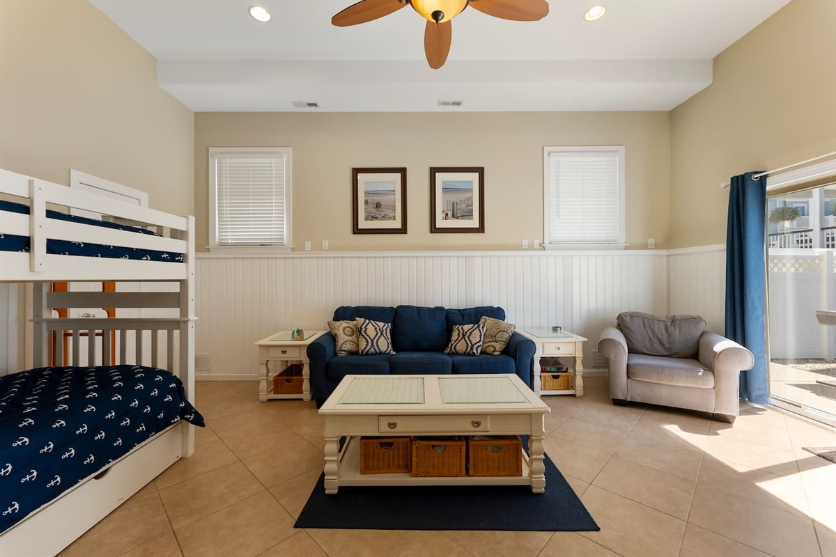 Bonus room with HDTV, Foosball Table, Bunk beds and ample seating for games and entertaining. With direct access to private fenced in yard featuring BBQ Grill. 