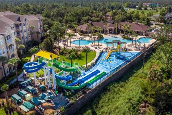 Heated zero entry lagoon style pool, water slides and splash zone all included with your villa rental.