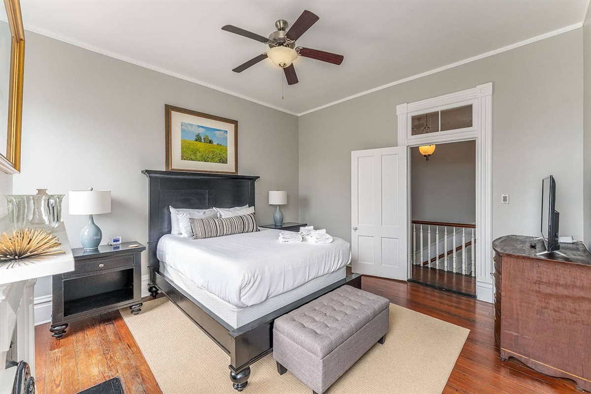 Well appointed bedroom with a queen mattress and high-end furnishings.  Two large windows between the ornate slate fireplace invite you in to kick your feet up and watch the game, read a book, or take a guilt-free nap.