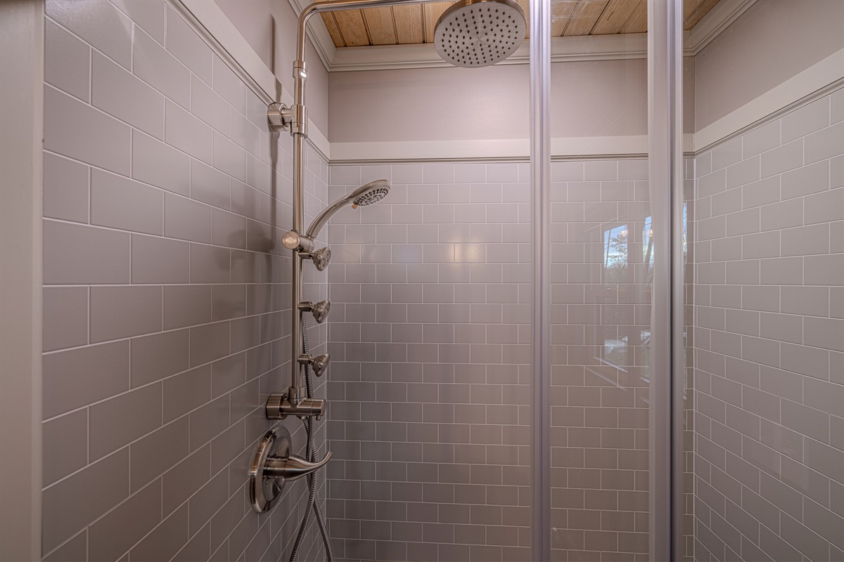 Master Suite #1 ensuite bath features a luxury rainfall shower head with body jets.