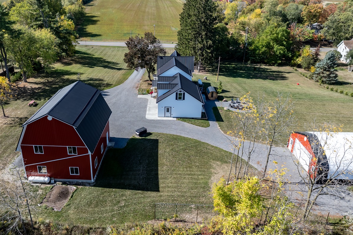 Spacious farmhouse and classic red barn surrounded by rolling countryside — the perfect Finger Lakes escape