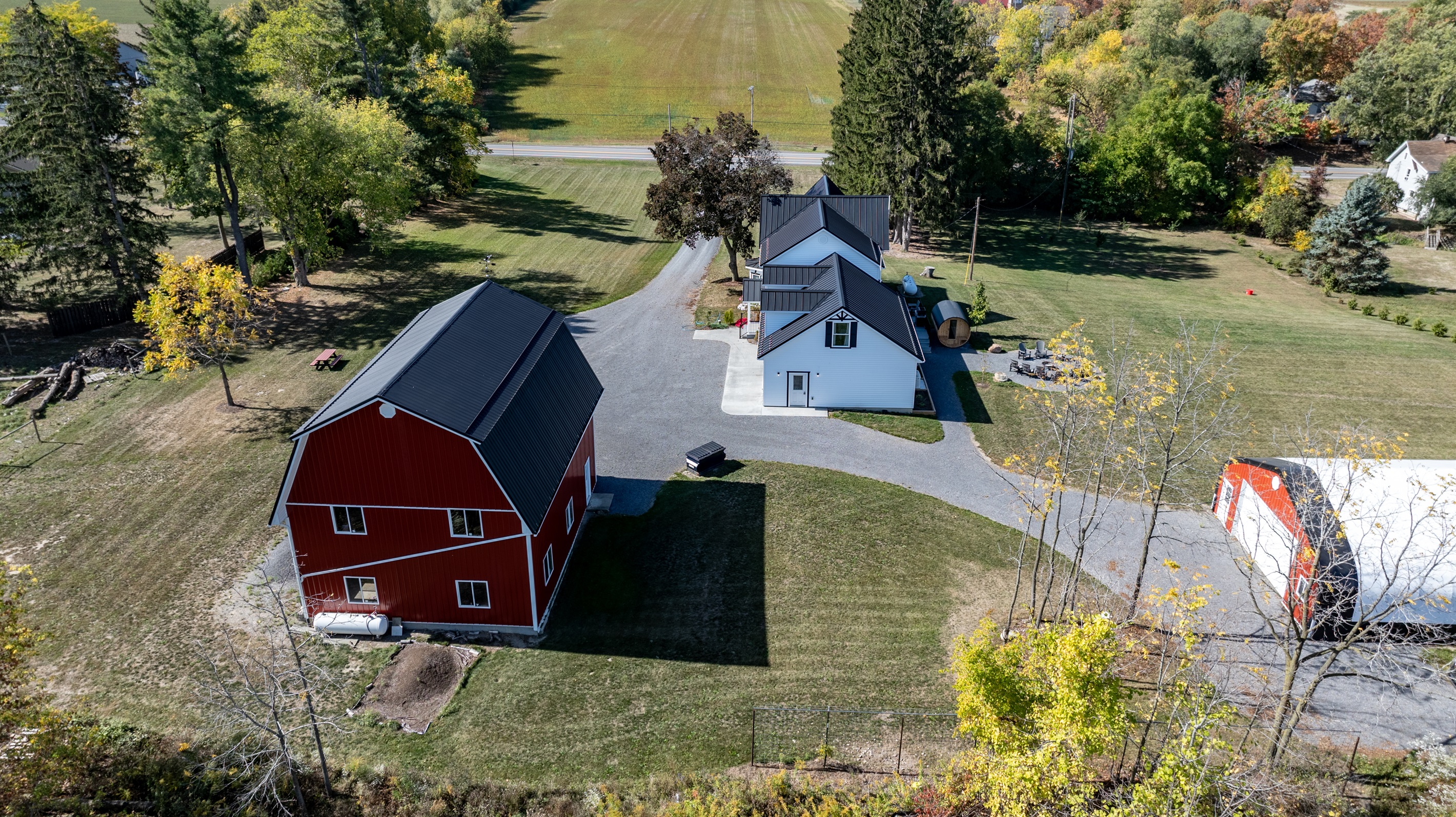 Spacious farmhouse and classic red barn surrounded by rolling countryside — the perfect Finger Lakes escape