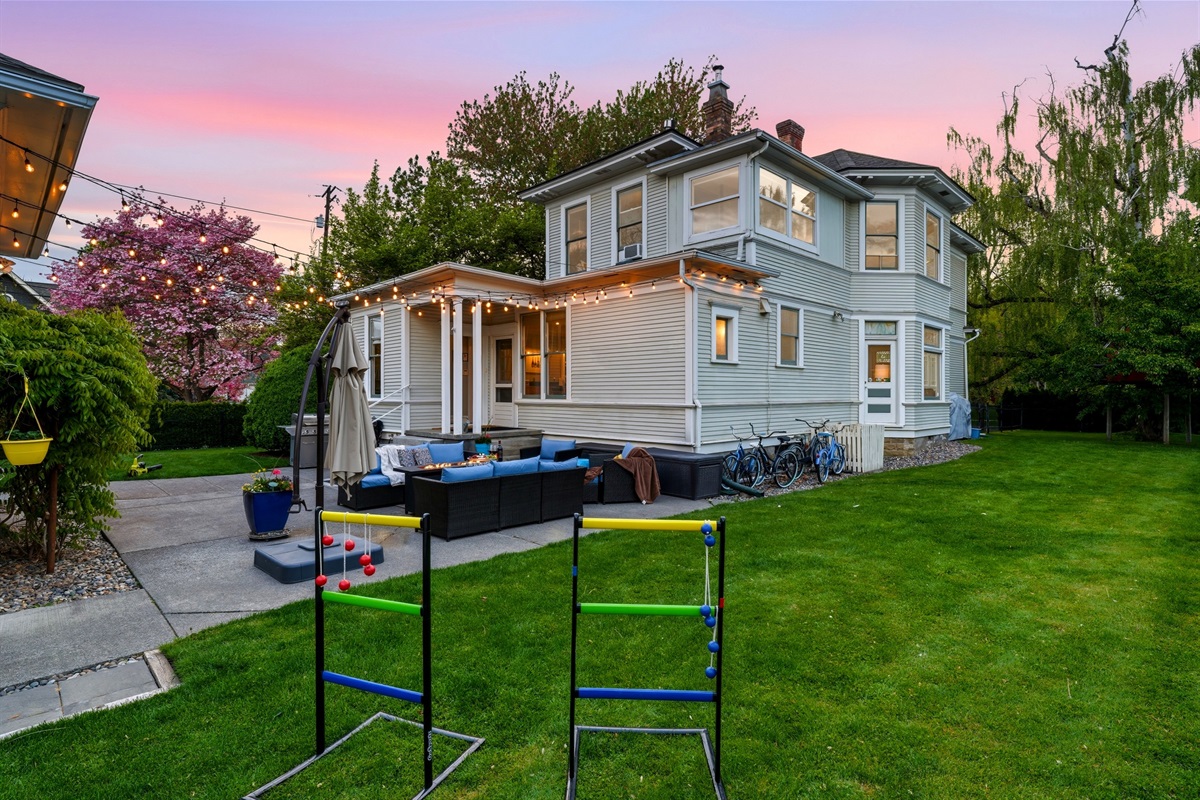Back patio, surrounded by mature trees and historic charm and equipped with lounge seating and BBQ (propane provided)