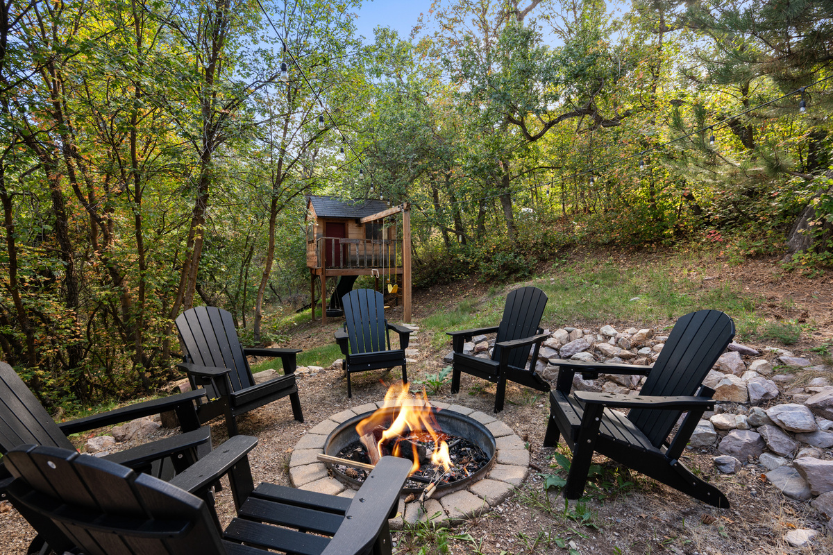 Wooded fire pit retreat with plenty of seating for the group.