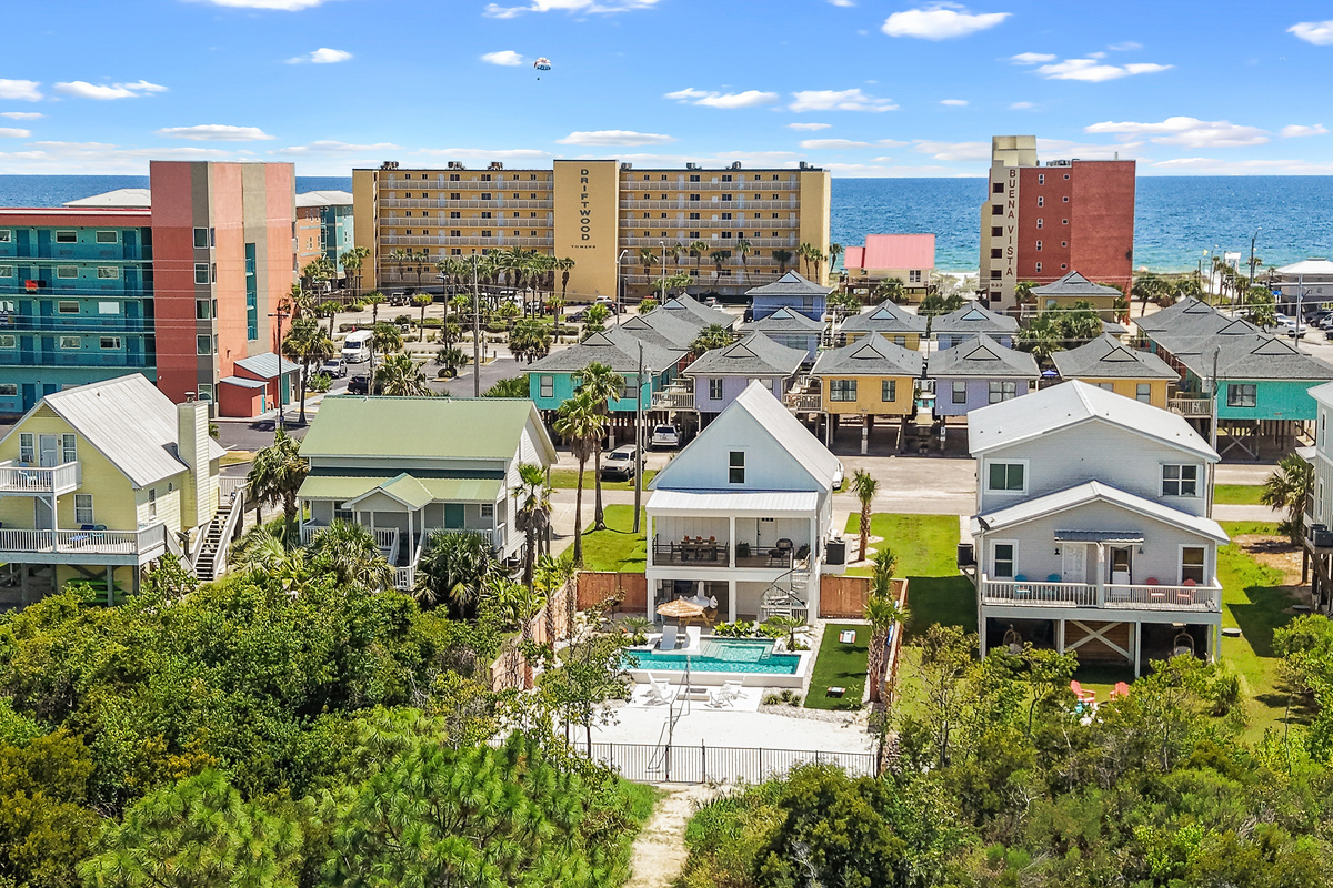 Aerial view showing the home’s central Gulf Shores location with the Gulf just beyond.
