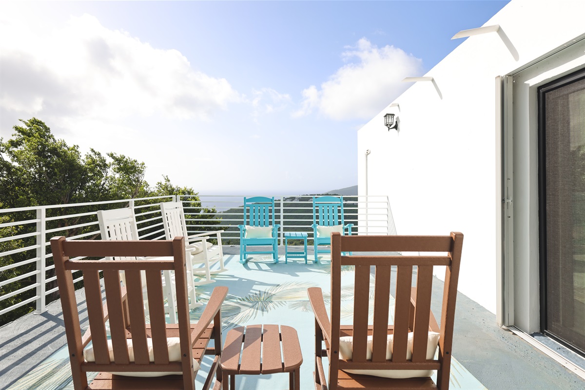 Private balcony with outdoor lounge seating for island mornings.