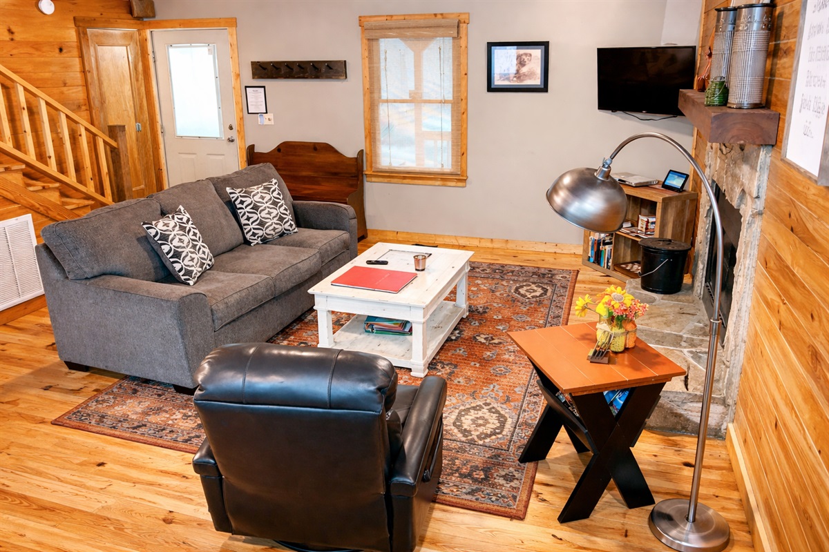 Relax in the cozy mountain living room—plush seating, warm wood accents, and the perfect spot to unwind after a day exploring North Georgia.