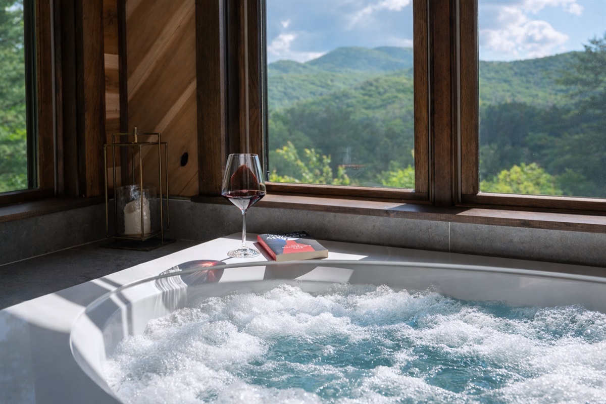 Soak your worries away in this tub with expansive views of the lush green mountains.