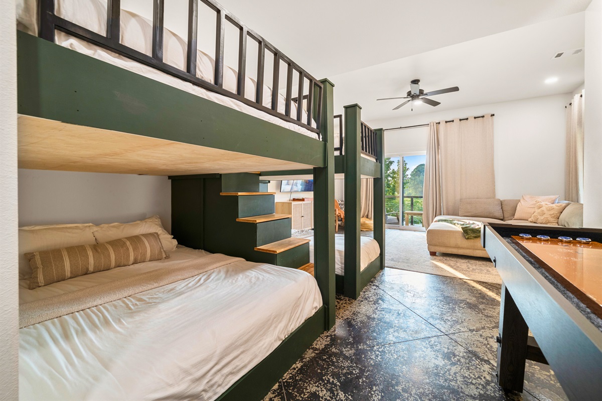 Spacious bunk room with entertainment area and access to the outdoor patio.