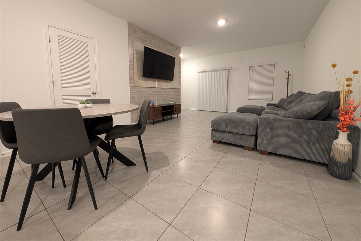 4 place kitchen table with a view of the TV in the background