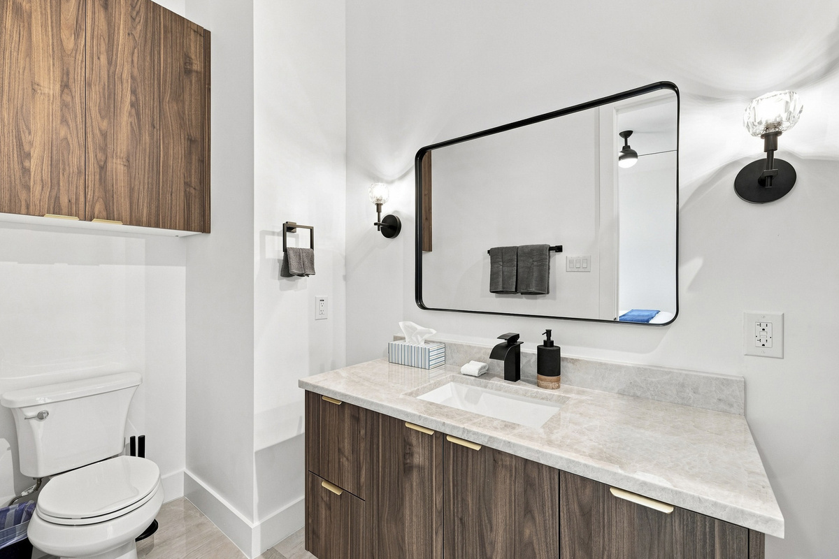 Sleek vanity and bright lighting create a fresh, inviting space for your stay!