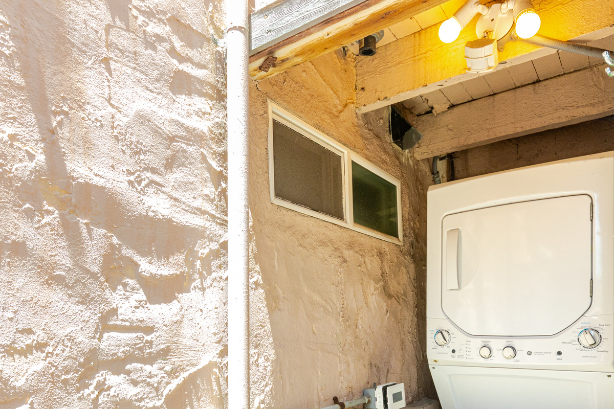 Exterior laundry room is located on the east side of the house.  It includes a stacked washer and dryer that is shared with the guests in the attached apartment.