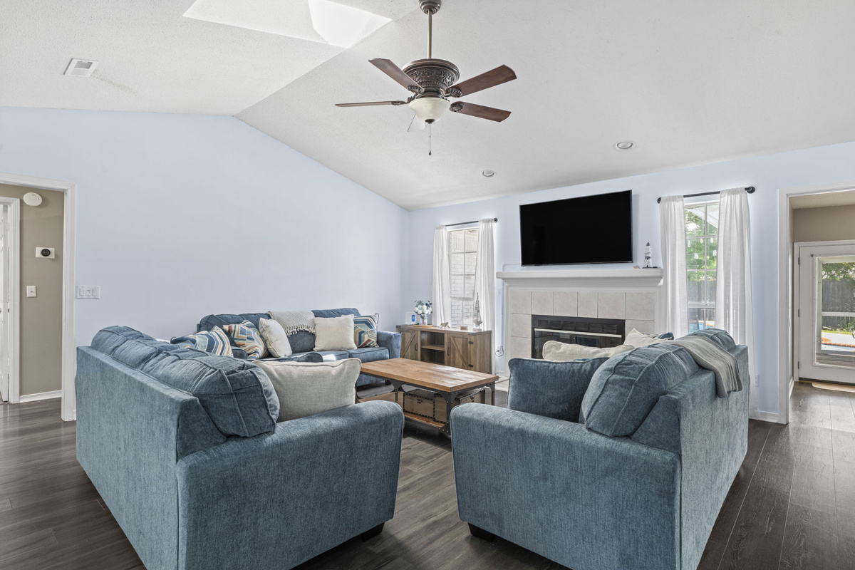 Sink into plush, oversized seating for the whole group — with a mounted TV and cozy fireplace as the centerpiece.