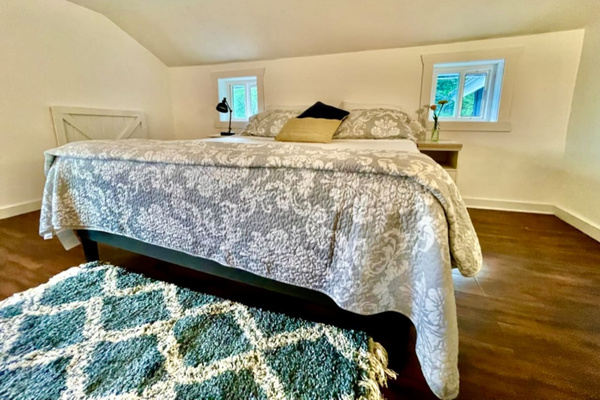 Cotton sheets and comfy mattress on King bed in upstairs bedroom. Blackout curtains for sound sleep. 