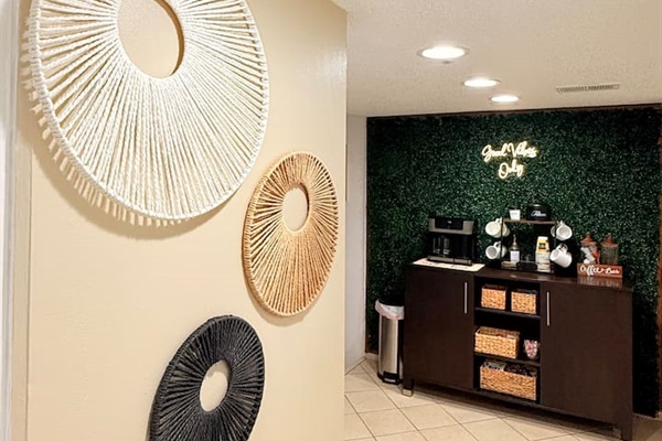 Start your mornings at the fully stocked coffee bar, complete with a stylish greenery backdrop and everything you need for a fresh brew.