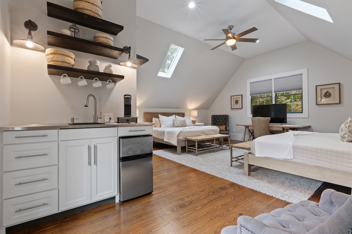 The carriage house features two king beds, a full bathroom, and a kitchenette, providing a comfortable and private space for guests.