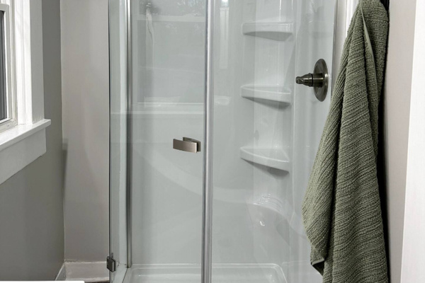 Rinse off in a sleek, spacious glass shower after a full day of exploring.
