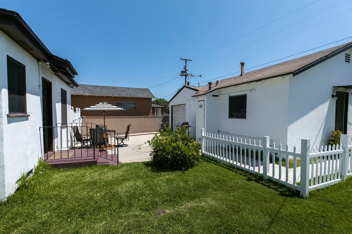 Main house to the left, detached "Bonus room"/studio suite to the right.  Sunny and spacious back yard. Safe, historic, walkable Heartwell Park neighborhood.