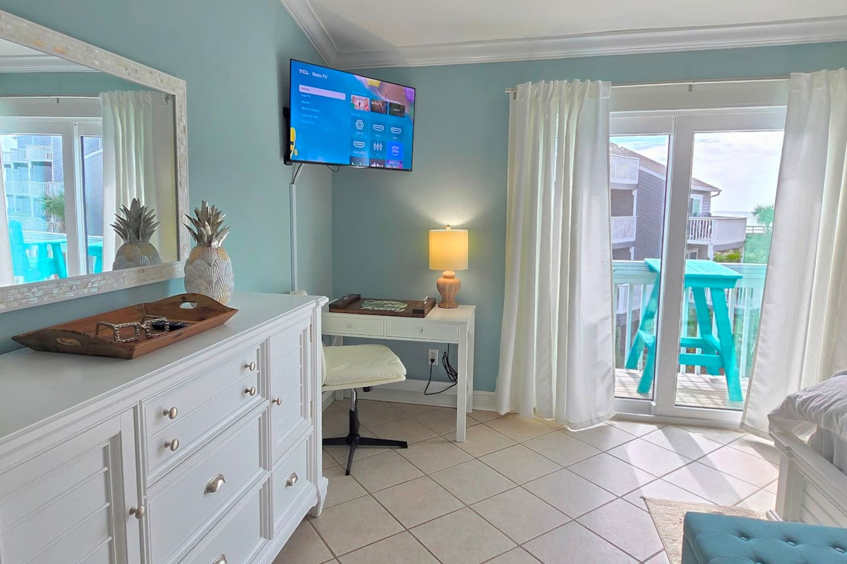 Settle into the king master suite &mdash; the Smart TV, private deck door, and dedicated desk are all here when you want them, invisible when you do not.