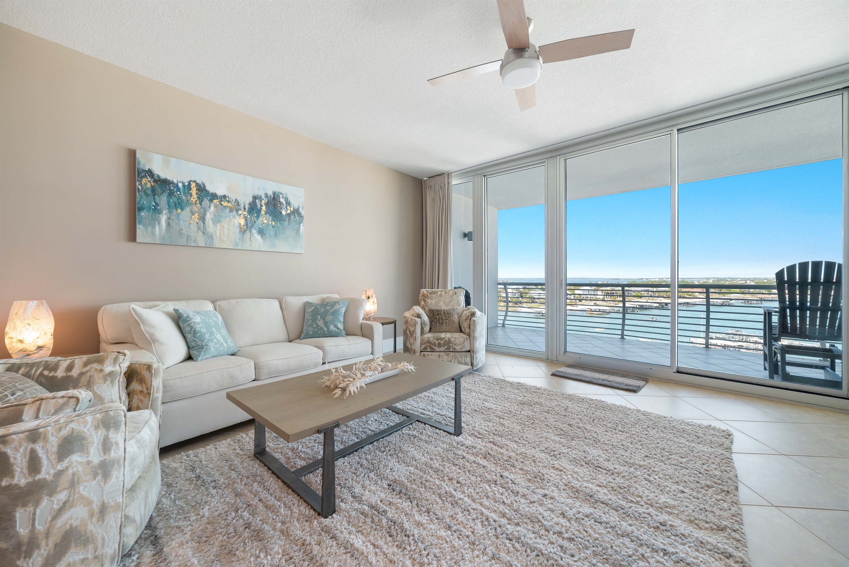 Spacious and inviting living area with floor-to-ceiling windows showcasing breathtaking panoramic views. This open-concept design seamlessly blends comfort and style, creating the perfect space for relaxation and entertainment.