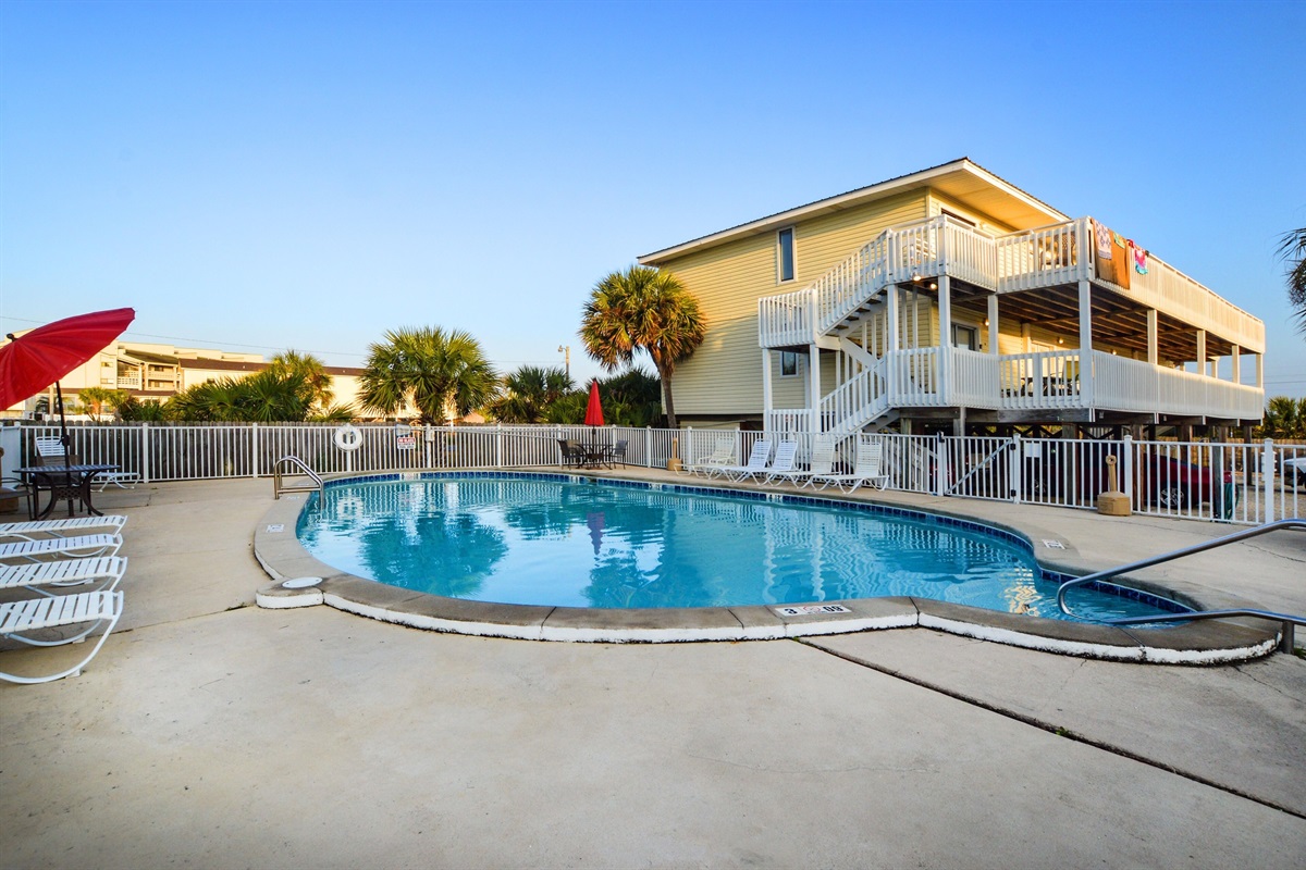 Outdoor Communal Pool - An outdoor pool is featured on site and offers seating for enjoying time in the sun.