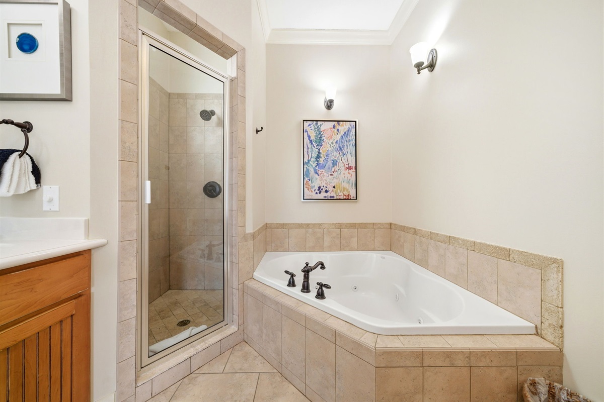 Indulge in a relaxing soak in the garden tub or a quick refresh in the glass-enclosed walk-in shower.