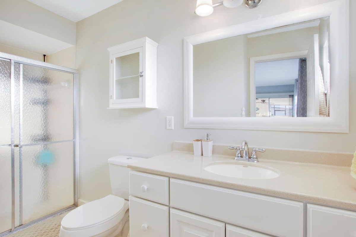  Main bedroom suite bathroom with glass shower door.