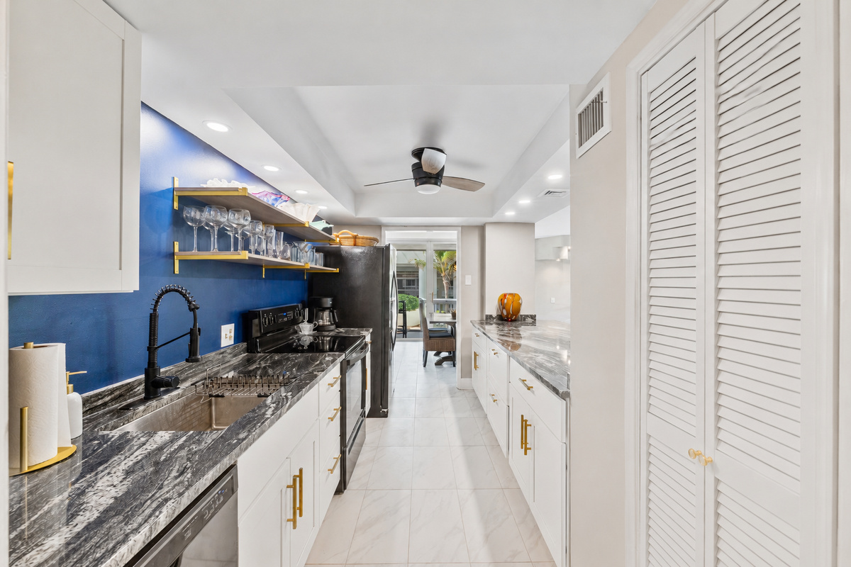 Fully stocked kitchen with cookware, plates, utensils, and all your dining essentials — plus a refrigerator with built-in ice maker and water filter.