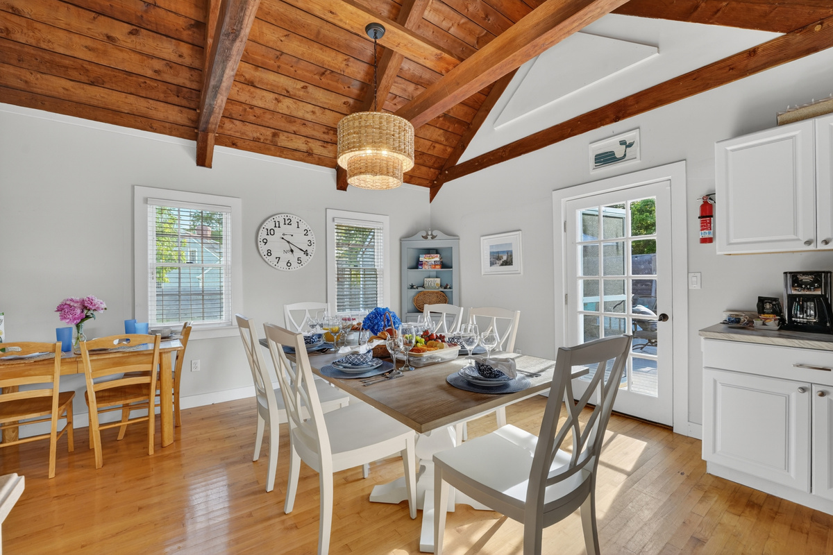 Bright and airy dining space featuring rustic wood ceilings, natural light, and an inviting atmosphere for shared meals.