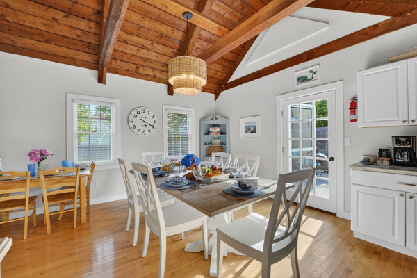 Bright and airy dining space featuring rustic wood ceilings, natural light, and an inviting atmosphere for shared meals.