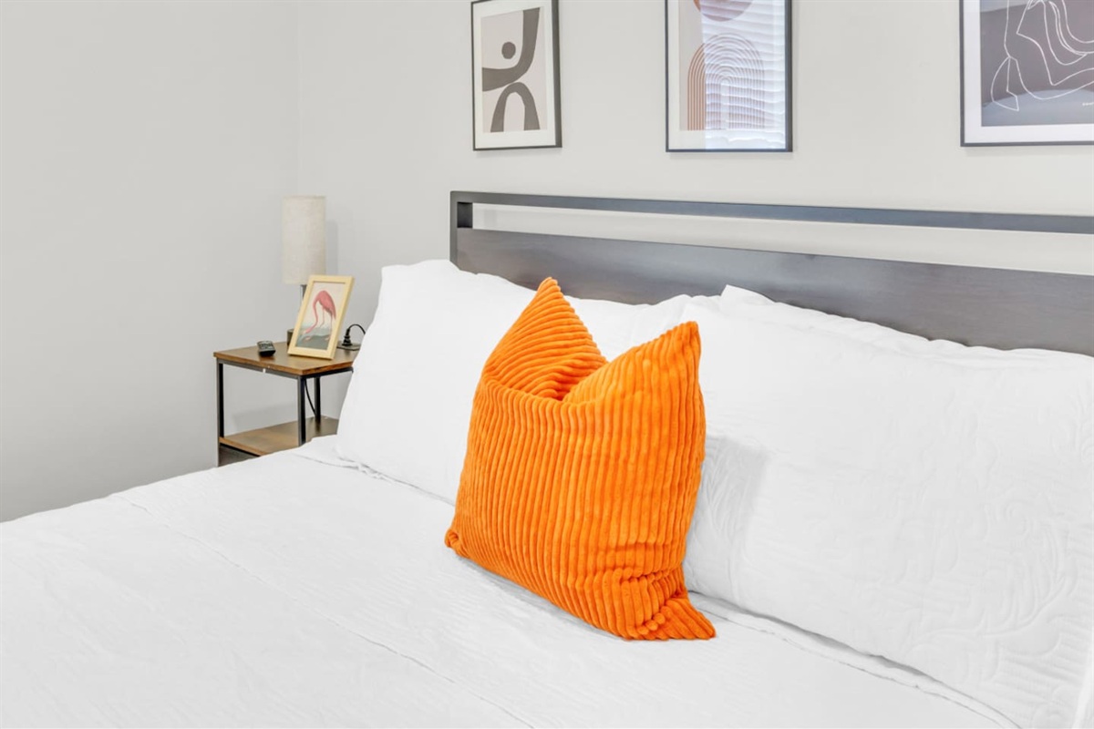 Bedroom with queen bed and large window views.