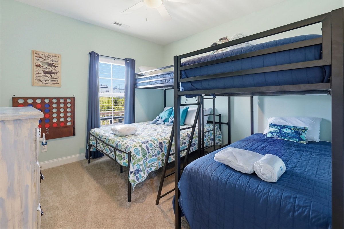 Spacious bunk room with queen, twin, and bunk beds&mdash;perfect for groups