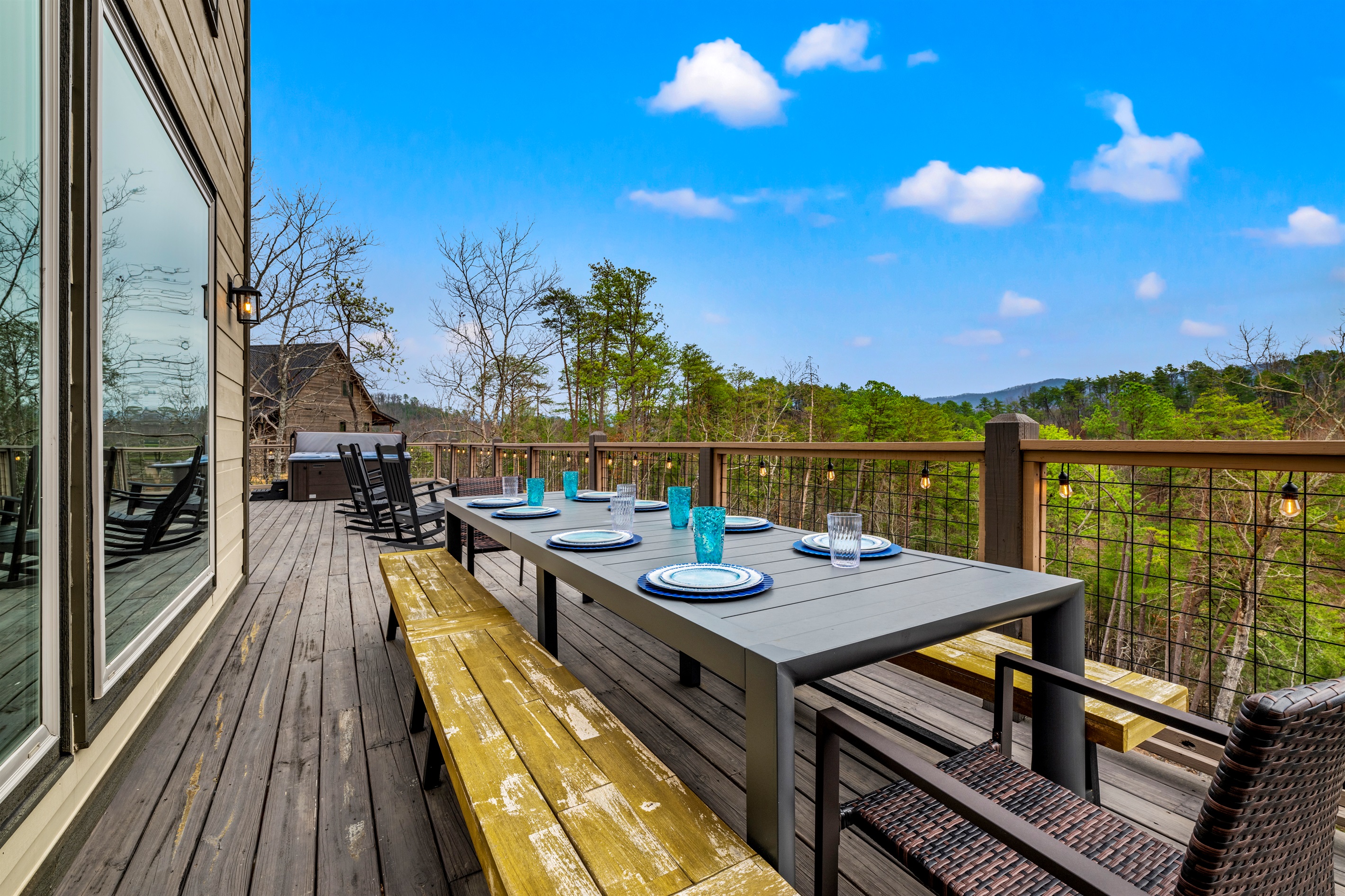 Outdoor dining on the deck, one of several spaces designed for entertaining your group while soaking in stunning Smoky Mountain views.
