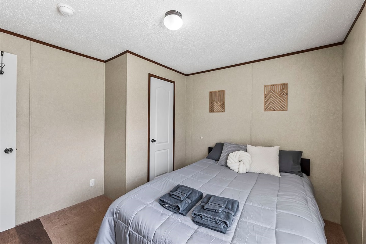 Bright and simple bedroom setup with neutral tones, cozy textures, and a peaceful ambiance for restful nights.