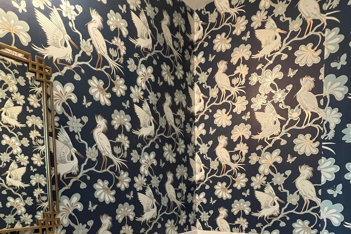 Newly enlarged powder room on main floor with beautiful tropical wall paper 