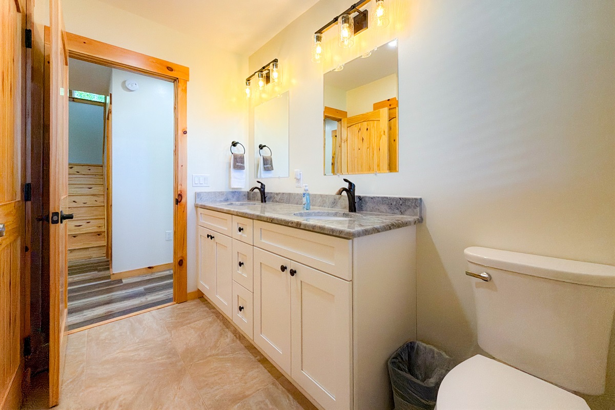 Guest Bathroom 1 on the Lower level. Full bathroom with tile shower and double vanity.