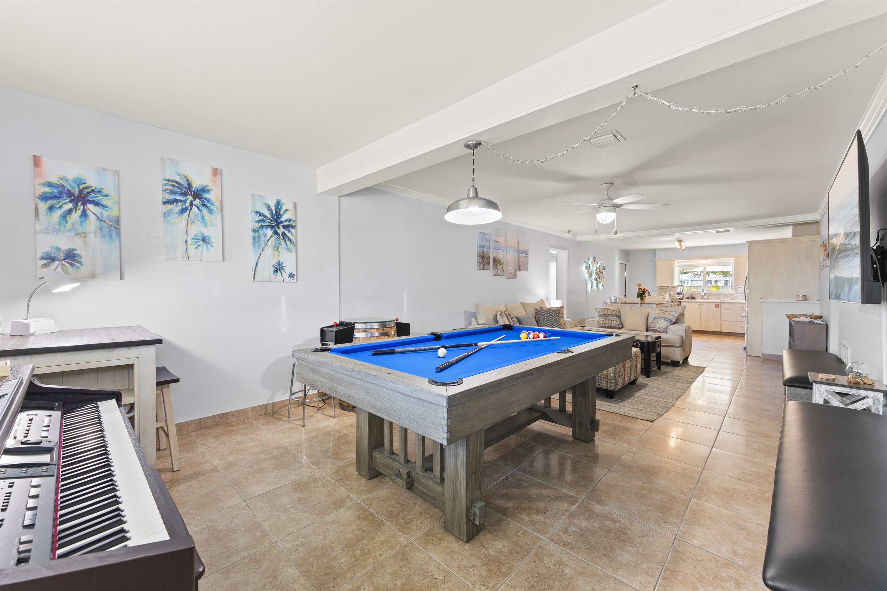 Piano, pool table, and arcade game in the living room