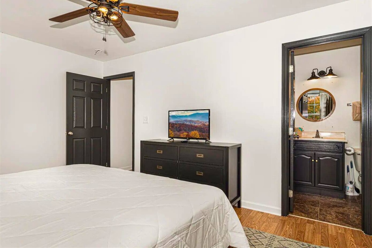 Comfort meets convenience in this bedroom equipped with a TV and easy access to your own private bathroom.