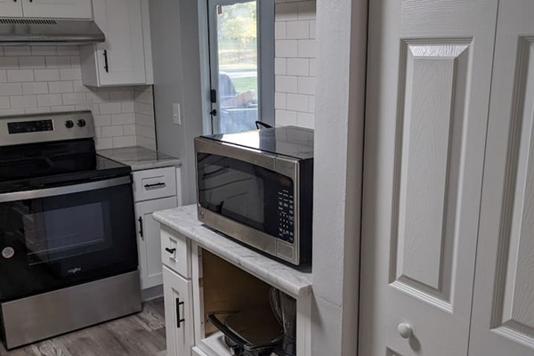 Kitchen connects with living room and dining room.  Complete with kitchen gadgets, microwave and plenty of utensils.