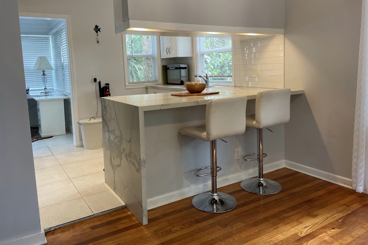 Two counter stools sit in the kitchen, a convenient place to enjoy coffee or breakfast.