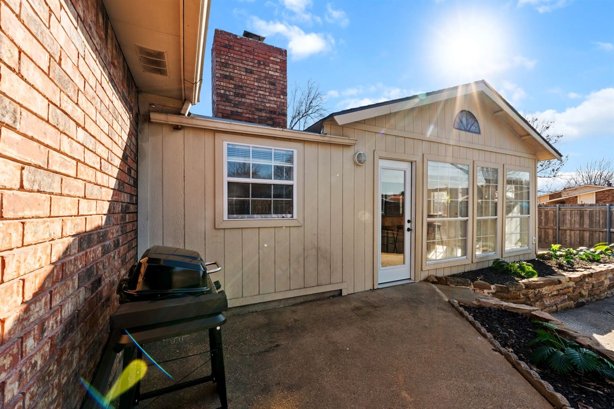 Grill up your favorites on the backyard BBQ just steps from the sunroom—perfect for outdoor dining and entertaining under the Texas sun.
