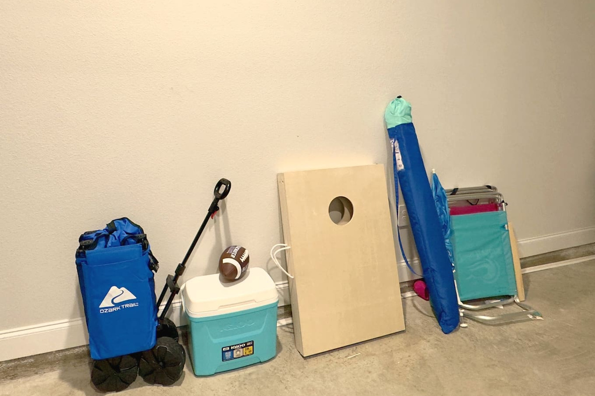 Grab the cornhole boards, football, cooler packed and ready. Beach chairs stacked, easy to load up and go. Everything set for a fun day outside, no planning required.