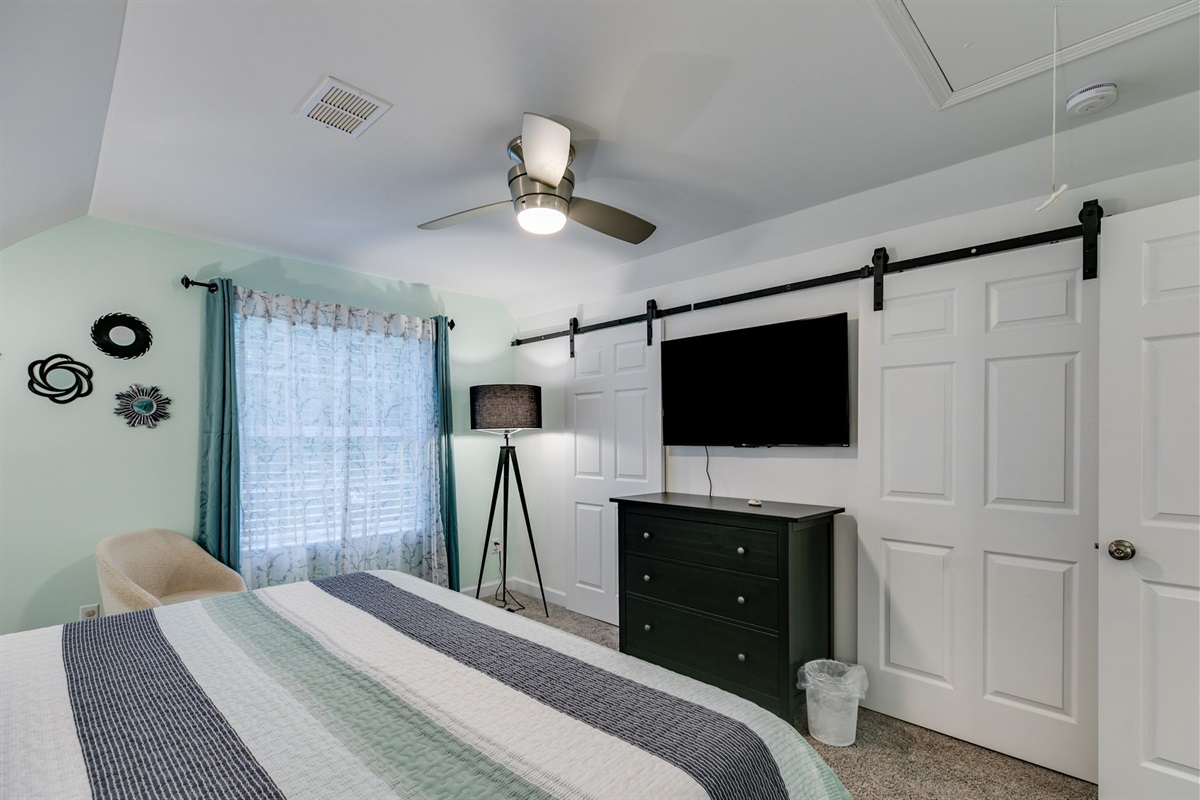 Relax in style in our spacious bedroom, featuring a plush king-size bed perfect for a restful night, cozy lighting for unwinding, and a 50-inch smart TV for your favorite shows and movies.
