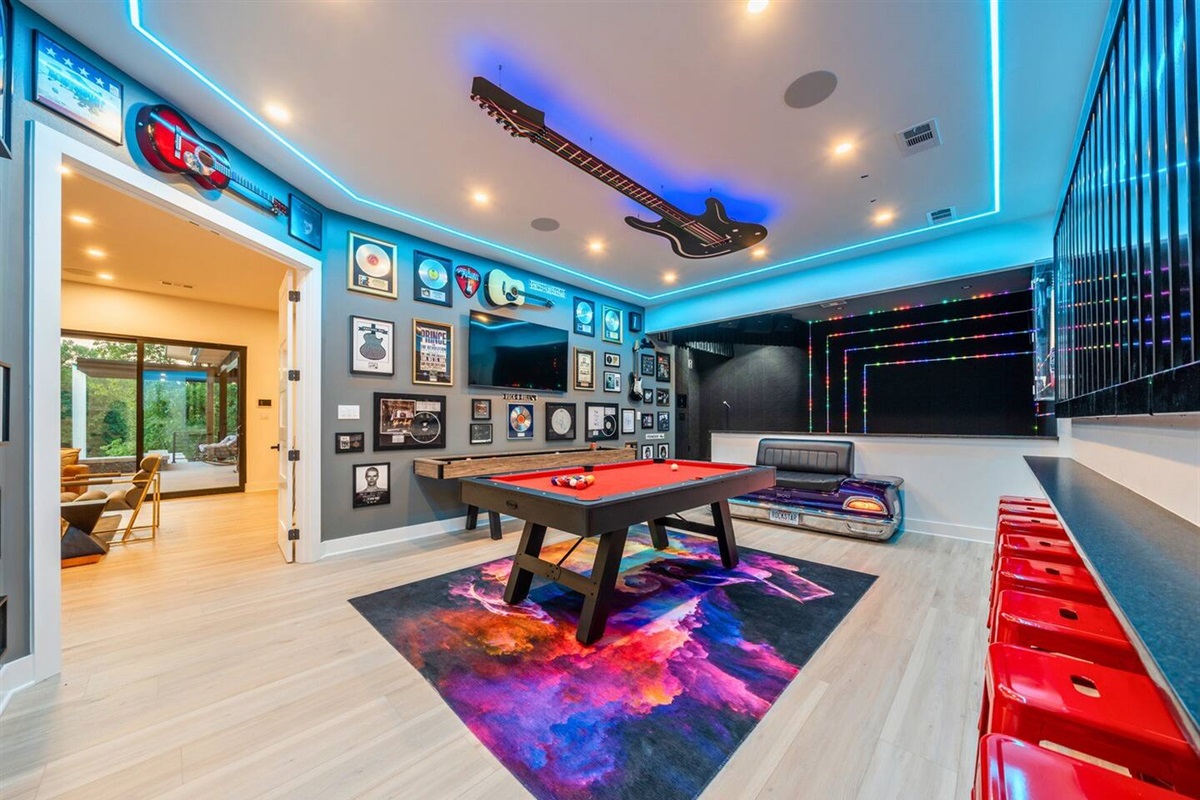 Bright lights, bold colors, and endless fun. This game room is the heart of home entertainment