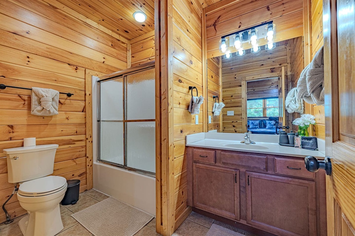 Private en-suite bathroom connected to each king bedroom. Five full bathrooms &mdash; no waiting, no sharing. Gatlinburg cabin sleeps 12.