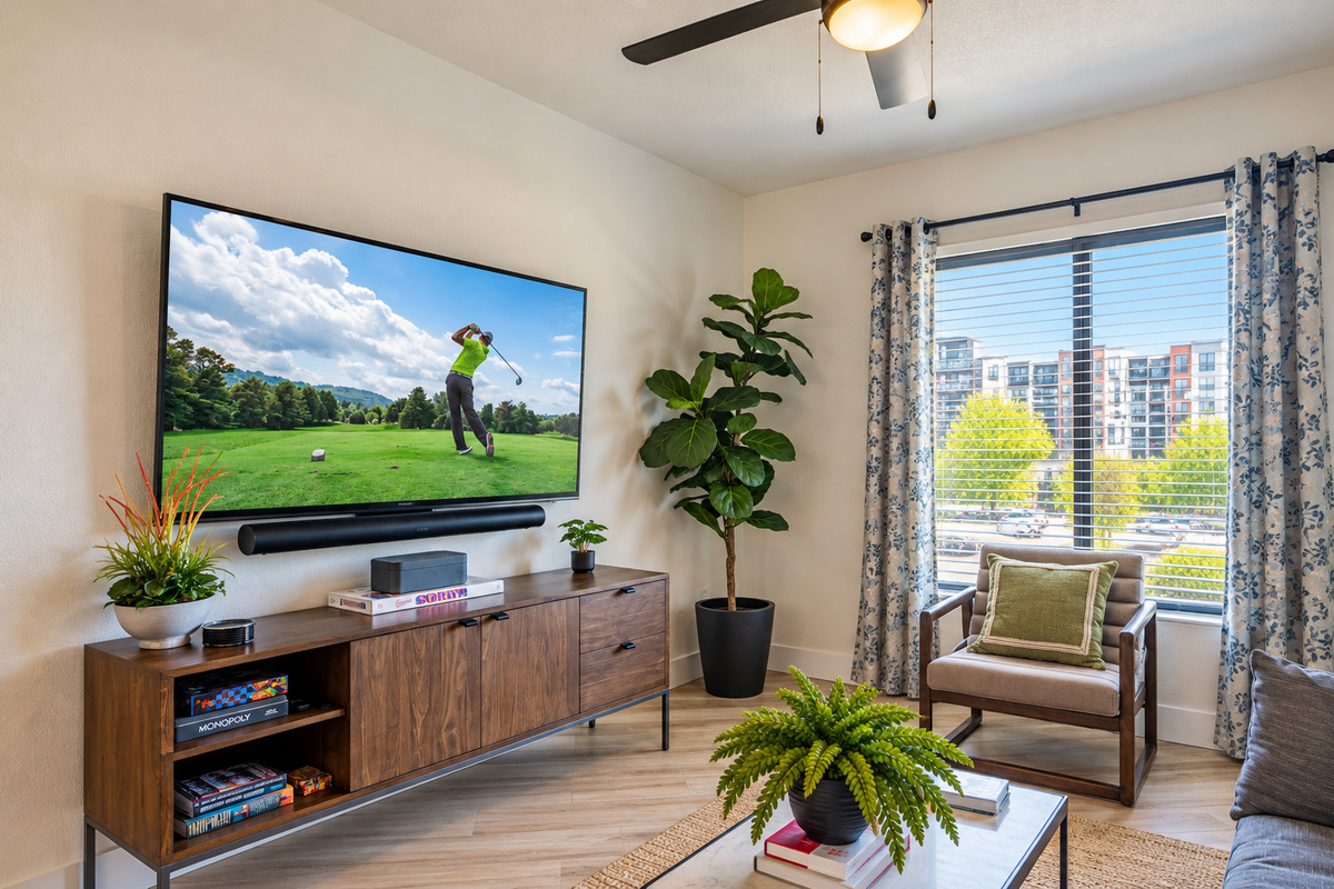 - Bright and airy living area with a large TV and natural light views   - Comfortable seating and open access to the kitchen for easy flow   - Perfect for lounging after poolside fun or nearby golf outings