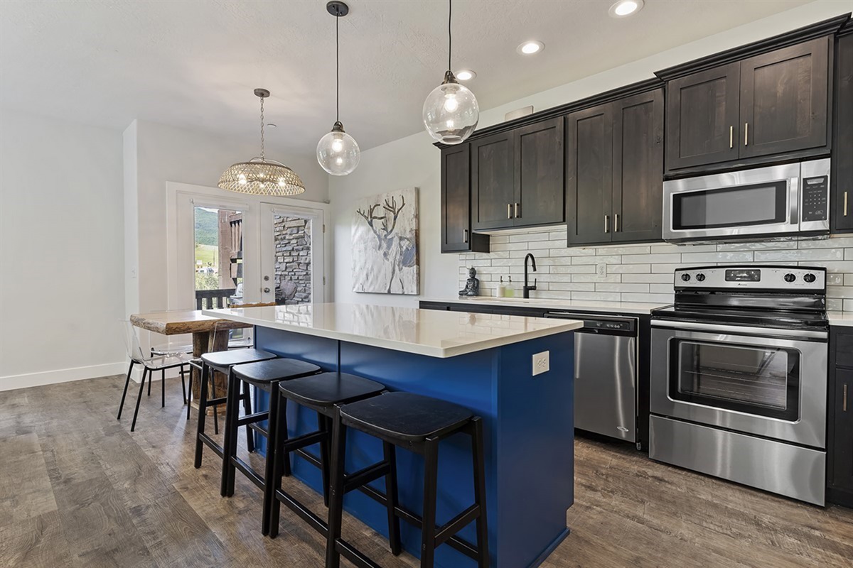 Entertain with ease in a designer kitchen featuring premium finishes, stainless steel appliances, and a striking island that invites both conversation and culinary creativity.