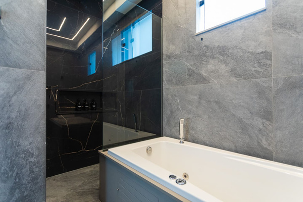 Large walk in rain head shower.   Brand new jacuzzi tub with jets!